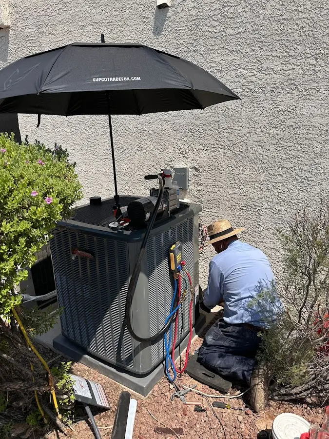 HVAC technician performing outdoor AC maintenance in Westmont